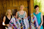 Winner Nemaiah Shaw (centre) receives the quilt from Kathy Moore (left) and Jan Micklethwaite (right).