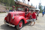 Kids playing on Rossland's old fire truck, Rossland Museum. 